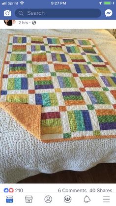 a bed with a quilt on top of it