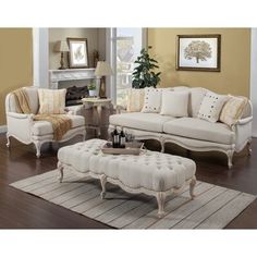 a living room filled with furniture and a rug on top of a hard wood floor