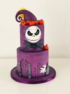 a three tiered cake decorated with halloween decorations