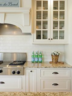 a kitchen with white cabinets and granite counter tops