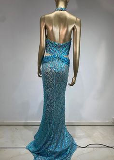 The ALISHA Sequined Maxi Dress is a stunning evening dress crafted with a plunging neck and a halter design. Its floor length, mermaid hem and backless feature ensures a dramatic and alluring look. With shimmering sequins in a beautiful sky blue, this dress is perfect for any special occasion. Fabric: Non-Stretch Material: Polyester Fiber *Actual color may vary slightly due to photo lighting and display screen color differences. Glamorous Floor-length Backless Dress For Gala, Glamorous Maxi Dress With Back Opening For Prom, Glamorous Backless Gown For Gala, Backless Mermaid Dress For Prom Season, Backless Mermaid Dress For Prom, Glamorous Backless Evening Dress With Sweep Train, Fitted Halter Neck Mermaid Dress For Evening, Backless Evening Gown For Gala, Backless Gala Gown For Evening