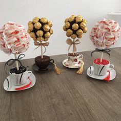 four different types of chocolates in cups and saucers on a wooden table top