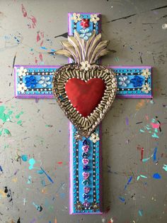 a cross with a red heart on it