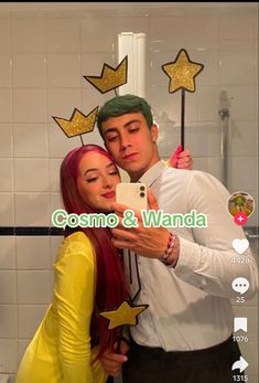 a man and woman taking a selfie in front of a mirror with stars on it