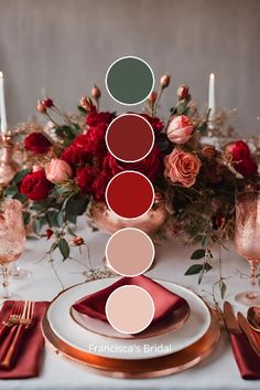 the table is set with red and pink flowers