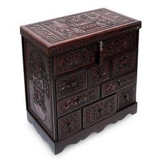 an ornate wooden chest with carvings on it