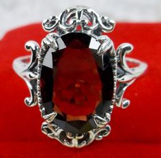 Natural Garnet Ring, Sterling Silver Filigree, Gothic Jewelry Inspired by Gothic & Renaissance era jewelry, this lovely antique style ring is handcrafted in solid sterling silver. This gorgeous ring is set with a near flawless natural red garnet gemstone. Garnet Ruby Ring With Intricate Design As Gift, Ornate Garnet Ruby Ring As Gift, Victorian Garnet Ring Gift, Victorian Silver Ring With Garnet, Victorian Style Garnet Silver Ring, Victorian Garnet Silver Ring, Ornate Oval Garnet Ring, Antique Silver Garnet Rings, Victorian Sterling Silver Ruby Ring