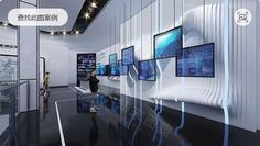 people are looking at televisions on display in a room with black floors and white walls