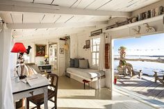 a living room filled with furniture next to a lake