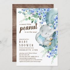 a baby shower with an elephant and blue flowers