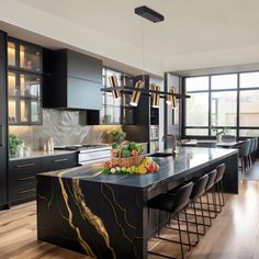 a modern kitchen with black cabinets and marble island in the center, surrounded by bar stools