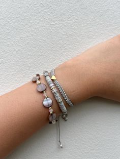 Handcrafted with the macrame technique, this adjustable trio of bracelets combines natural mother-of-pearl, genuine seashells, and stainless steel pendants for a unique, ocean-inspired look. Perfect for layering or wearing individually, these bracelets are designed to fit comfortably on any wrist. Made from hypoallergenic, eco-friendly materials and featuring durable stainless steel, they are ideal for those with sensitive skin. At Alfen Shop, we prioritize natural materials, ensuring your jewel Adjustable Mother Of Pearl Bracelets As Gifts, Adjustable Mother Of Pearl Bracelets For Gifts, Adjustable Mother Of Pearl Bracelet As Gift, Adjustable Mother Of Pearl Bracelets With Oyster Design, Adjustable Oyster Pearl Bracelet, Adjustable Mother Of Pearl Oyster Bracelet, Resizable Silver Beaded Bracelets For Beach, Resizable Silver Beaded Bracelet For The Beach, Silver Beaded Bracelet With Oyster Design