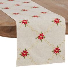 a table runner with poinsettis on it