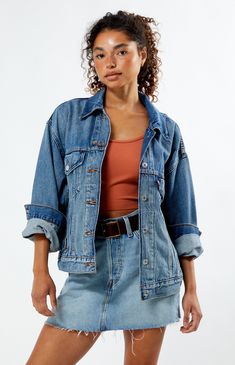 Introducing the Medium Indigo '90s Denim Trucker Jacket from Levi's, crafted from durable rigid cotton for timeless appeal. Featuring a pitched silhouette for a distinct '90s vibe, it pays homage to the iconic Levi’s® Trucker Jacket with a relaxed fit, rounded drop shoulders, long sleeves, and a narrow waist for that classic bubble look.


	Medium indigo wash
	Rigid fabric
	Long sleeves
	Collar
	Button-down front closure
	Button-flap chest pockets
	Pitched silhouette
	Relaxed fit
	Dropped shoulders
	Narrow waist
	100% cotton
	Machine washable
	Model is wearing a size small
	Model measurements: 5’7” height, 32” bust, 24” waist, 35” hip Fall Medium Wash Rigid Denim Jacket, Spring Dark Wash Rigid Denim Jacket, Medium Wash Rigid Denim Outerwear For Fall, Retro Dark Wash Relaxed Fit Outerwear, Fall Medium Wash Rigid Denim Outerwear, Relaxed Fit Rigid Denim Jacket For Fall, Vintage Rigid Denim Jacket For Fall, Vintage Denim Outerwear For Fall, 90s Style Relaxed Fit Denim Jacket With Long Sleeves