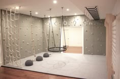 an empty room with swings and balls on the floor