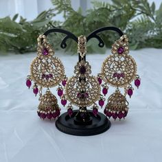 Kundan jewelry set includes a pair of earrings and a tikka. Colour: purple/plum Traditional Purple Earrings For Celebration, Purple Earrings For Festive Occasions, Purple Festive Earrings For Festivals, Purple Earrings For Festivals, Elegant Purple Jewelry For Festivals, Purple Latkans Earrings For Party, Purple Latkans Jewelry For Party, Elegant Purple Meenakari Jewelry, Purple Party Earrings With Latkans