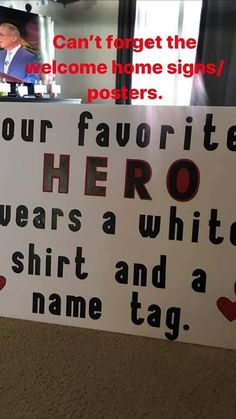 a sign that says, can't forget the welcome home signs / posters your favorite hero wears a white shirt and a name tag