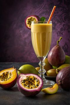 a smoothie in a glass surrounded by fruit on a black table with purple background