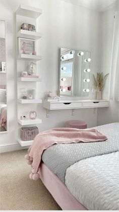 a white and pink bedroom with shelves, bed, mirror and other items on the wall