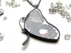 It is handcrafted exclusive design pendant made with glass and real butterfly wings. Each of our pendants can not be repeated exactly. The pendant can be worn on both sides. It will be nice anniversary gift. All jewelry comes in a cardboard box ready to be gift wrapped. And other unique jewelry here https://www.etsy.com/shop/RosavaGlassStore We accept only PayPal. Item is ready to ship, we will send it within 1-3 bussines days after payment confirmation. We do not ship on Saturdays and Sundays. Handmade Black Butterfly Jewelry, Butterfly Pendant Necklace For Gifts, Butterfly Pendant Necklace As A Gift, Butterfly Pendant Necklace For Gift, Black Butterfly Necklace For Gift, Butterfly Shaped Necklace With Large Pendant, Handmade Black Butterfly Necklace, Wing-shaped Black Jewelry Gift, Black Wing-shaped Jewelry Gift