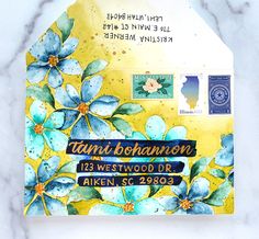 an envelope with blue flowers on it