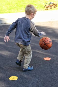 a young boy is playing with a basketball