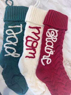 three knitted socks with the word hope written on them