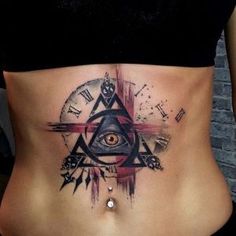 a woman's stomach with an all seeing eye tattoo