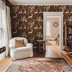 a living room filled with furniture and walls covered in deer wallpaper