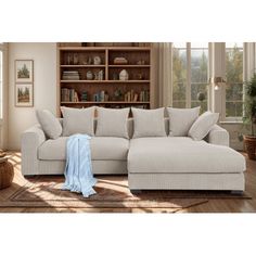 a living room scene with focus on the sectional sofa and pillows in the foreground