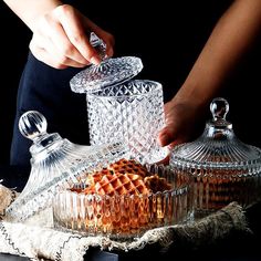 a person is decorating some glass dishes with waffles and butter on the table