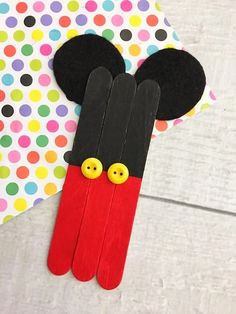 mickey mouse popsicle craft with polka dot paper and buttons on it's head