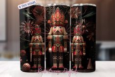 the three nutcrackers are painted in red and gold on this tumbler