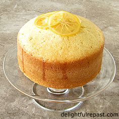 a cake on a glass plate with a lemon slice