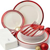 a red and white dinner set with silverware, napkins, and christmas decorations