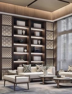 a living room filled with furniture and bookshelves next to a large glass window