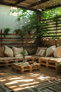 an outdoor living area with wooden pallets and plants