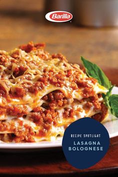 the lasagna bologne is topped with meat and cheese on a white plate