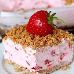 a piece of cake with a strawberry on top and crumbs in the middle