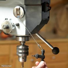 a person is working on a machine in a workshop