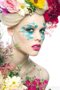 a woman with flowers painted on her face