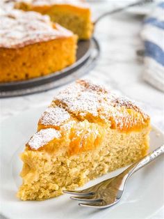 a piece of cake with powdered sugar on top and a fork next to it