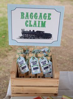 a table topped with lots of apples and bags next to a sign that says baggage claim