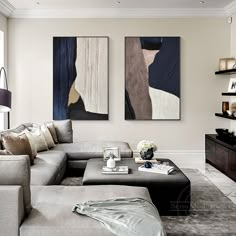 a living room with two paintings on the wall