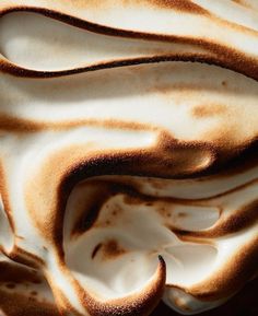 a close up view of a pastry with white frosting on it's surface