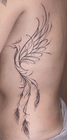 the back of a woman's stomach with feathers on it