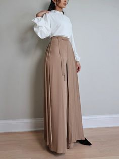 The set consists of wide cut pants with a beautiful Matching pleated overskirt. Pants are very modest and can be worn separately. 100% Polyester Super soft fabric There is a Separate Pleated and Separate style Detail Piece Side is Zippered Elastic waistband High rise 30.5" inseam Overskirt length for sizes S-L is 106cm Professional Wardrobe