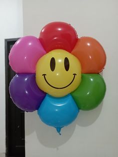 a bunch of balloons with a smiley face on them