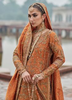 Orange Lehenga Designs Dress for Pakistani Bridal Wear, a gracefully embellished masterpiece that gives you a magnificent appearance at your wedding. Orange Indian Outfit, Orange Lehenga, Bridal Mehndi Dresses, Designs Dress, Red Bridal Dress, Wedding Lehenga Designs, Asian Bridal Dresses, Velvet Dress Designs, Latest Bridal Dresses