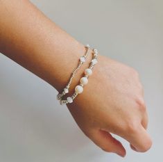 This handmade bracelet set features two elegant pieces that complement each other perfectly. The first bracelet is delicately crafted with small, silver-toned beads that add a touch of shimmer, while the second bracelet combines silver-toned beads with soft, iridescent pearls and star-shaped beads, creating a beautiful balance of textures. The pearls bring a classic, timeless feel, while the star-shaped beads add a whimsical, playful touch. This versatile set is perfect for adding a subtle yet sophisticated accent to any outfit, whether you're dressing up for a special occasion or adding a bit of charm to your everyday look. The neutral tones make these bracelets easy to mix and match with other jewelry. Perfect as a gift or a treat for yourself! Pearl Beaded Bracelet, Iridescent Pearl, Handmade Bracelet, Star Shape, Pearl Beads, Handmade Bracelets, Bracelet Set, Beaded Bracelet, Halloween Shopping